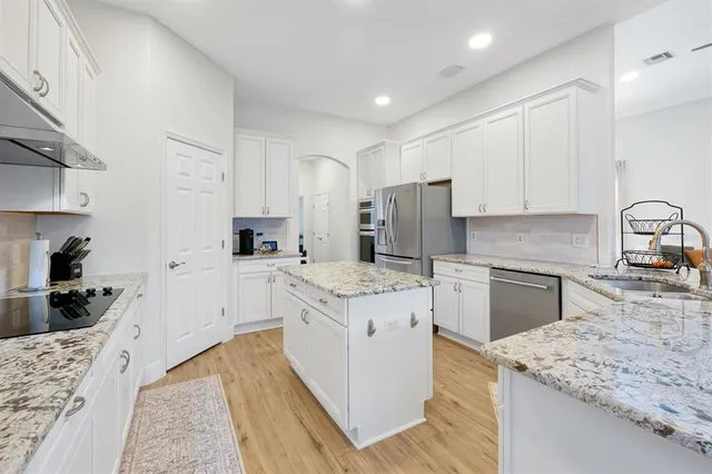 a dining room with furniture and a floor to ceiling window