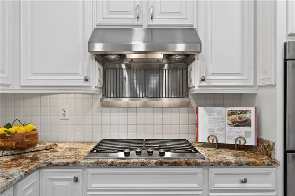 6460 Rutherford Place Suwanee, GA 30024 - Photo 12 of 35 a stove top oven sitting inside of a kitchen
