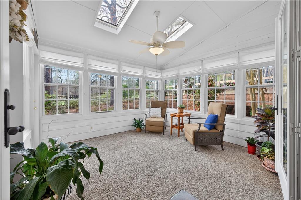 6460 Rutherford Place Suwanee, GA 30024 - Photo 17 of 35 a living room with patio furniture and a potted plant