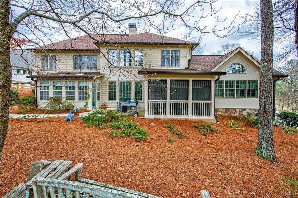 6460 Rutherford Place Suwanee, GA 30024 - Photo 20 of 35 a front view of a house with a yard and potted plants