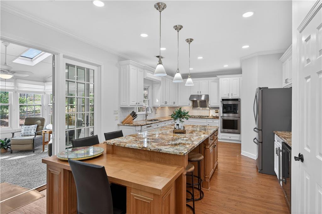 6460 Rutherford Place Suwanee, GA 30024 - Photo 2 of 35 a large kitchen with a table and chairs