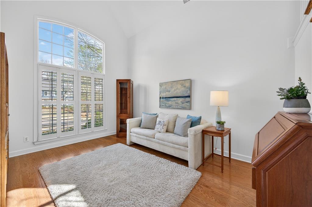 6460 Rutherford Place Suwanee, GA 30024 - Photo 5 of 35 a living room with furniture and a flat screen tv