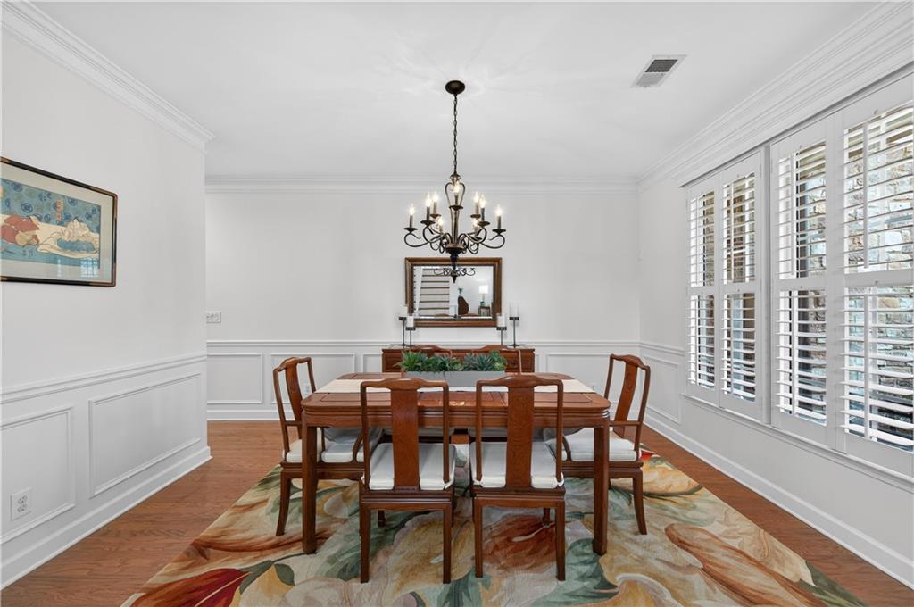 6460 Rutherford Place Suwanee, GA 30024 - Photo 6 of 35 a view of a dining room with furniture window and wooden floor