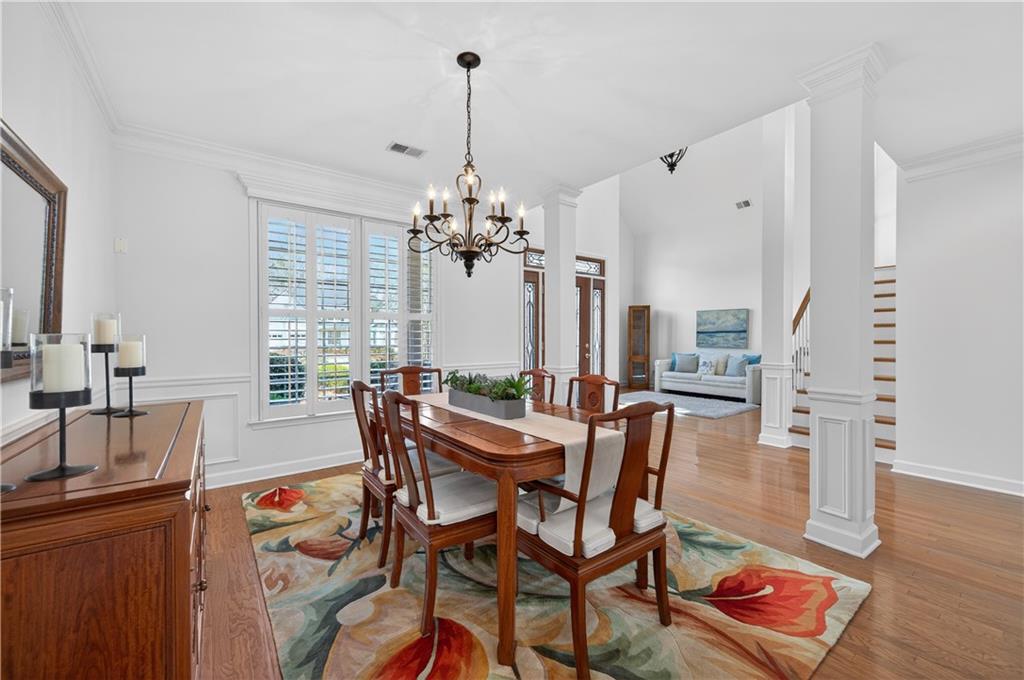 6460 Rutherford Place Suwanee, GA 30024 - Photo 7 of 35 a view of a dining room with furniture and wooden floor