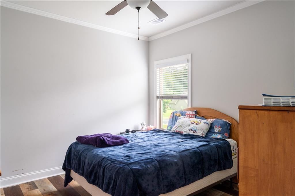 712 Fleeting Way Monroe, GA 30655 - Photo 18 of 29 a bedroom with a bed and window
