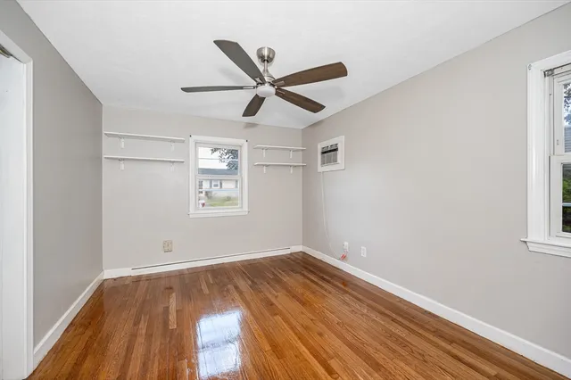 a view of empty room with wooden floor