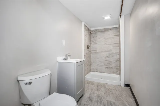 a front view of a house with a garden and yard