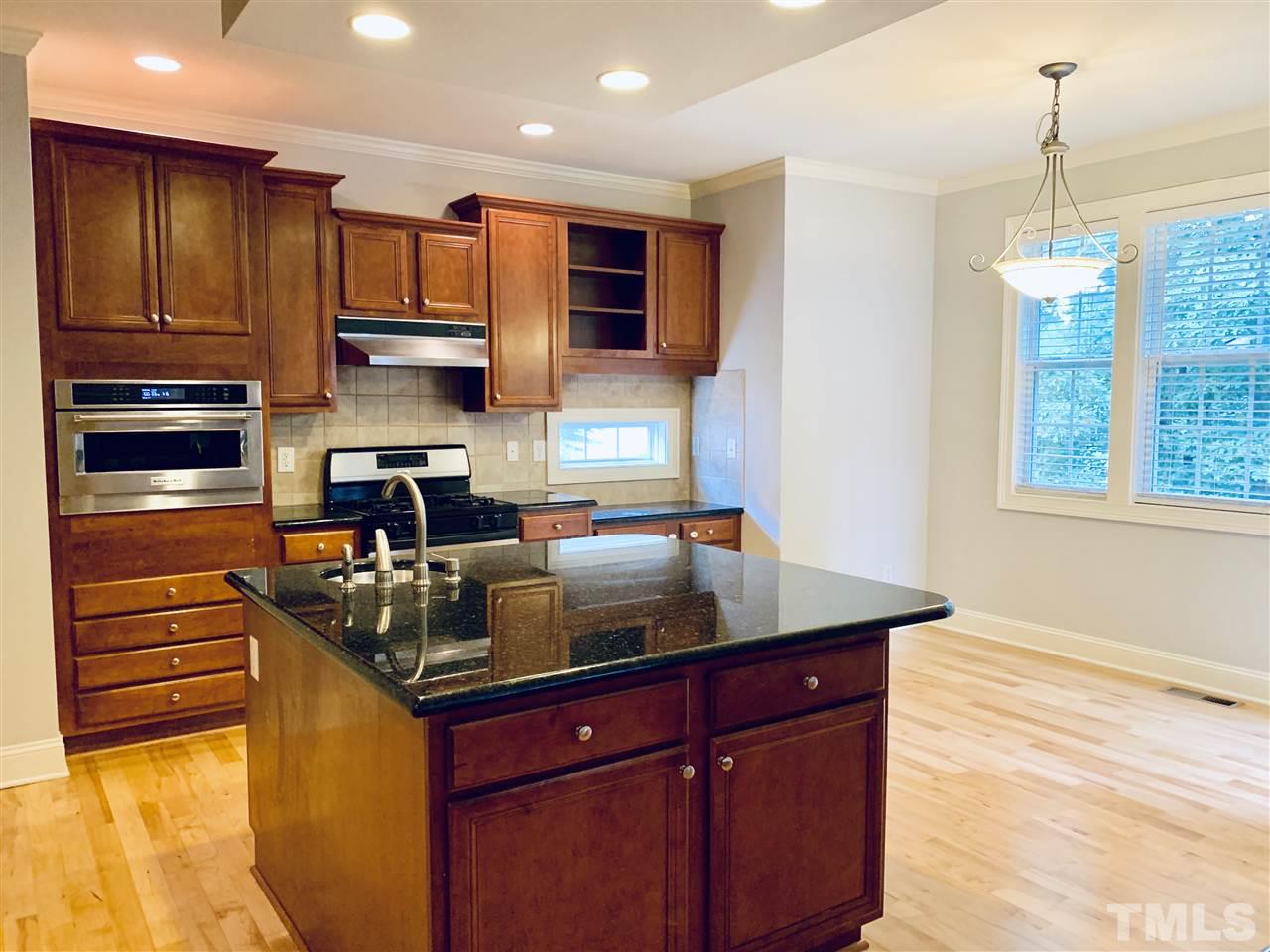 8917 Riverview Park Drive Raleigh, NC 27613 - Photo 11 of 29 a kitchen with stainless steel appliances granite countertop a sink and a stove
