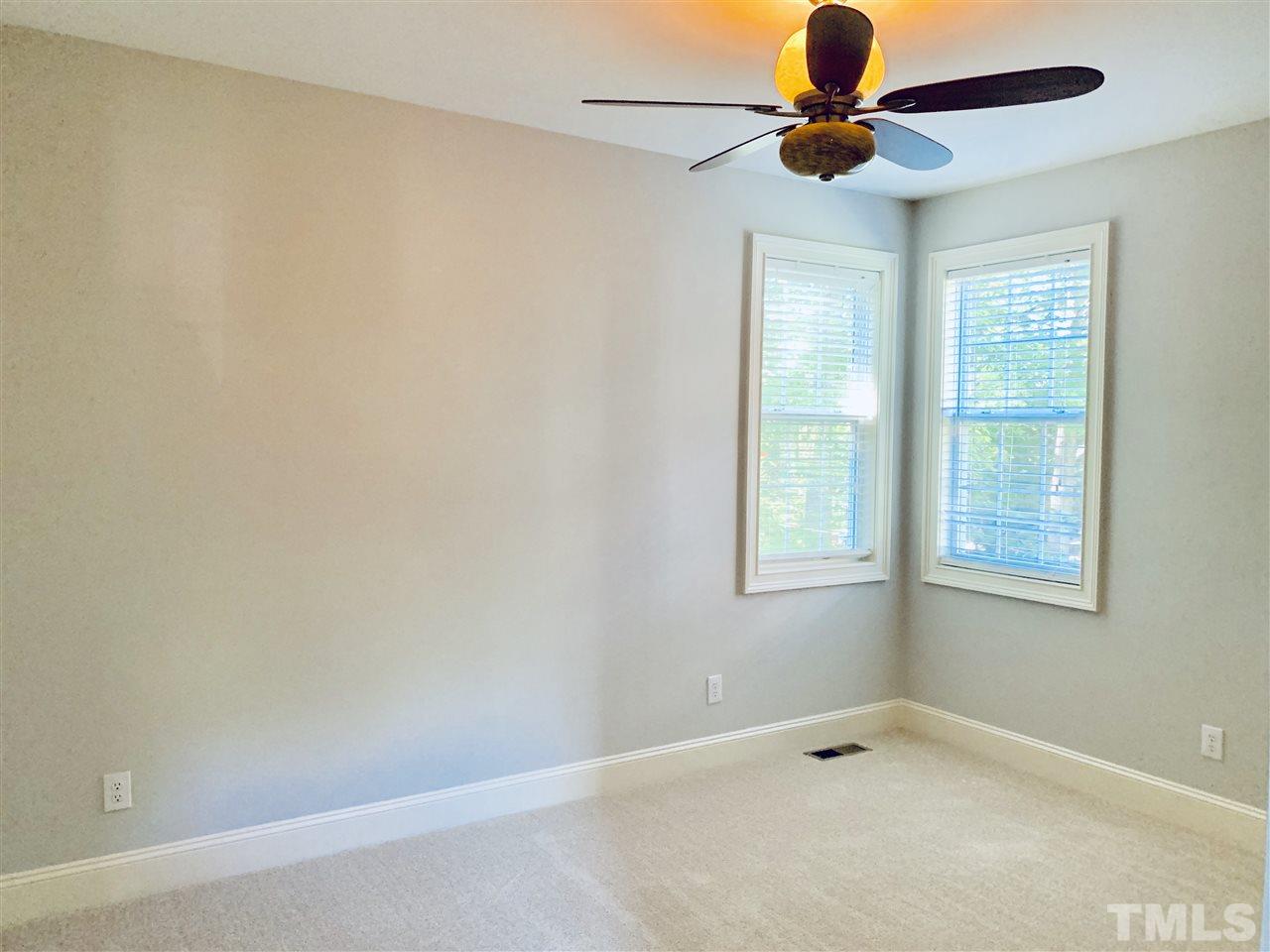 8917 Riverview Park Drive Raleigh, NC 27613 - Photo 13 of 29 an empty room with windows and fan
