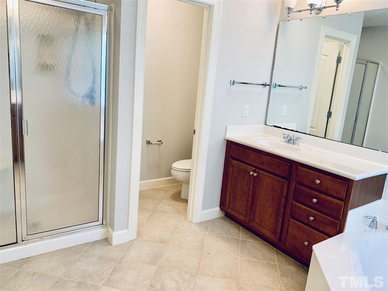 8917 Riverview Park Drive Raleigh, NC 27613 - Photo 19 of 29 a bathroom with a sink and a mirror
