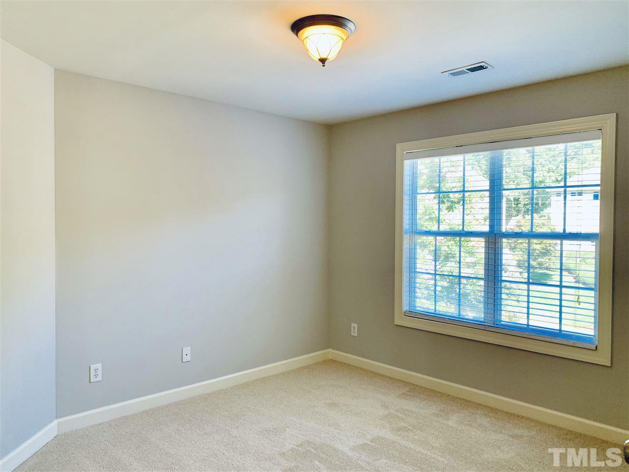 8917 Riverview Park Drive Raleigh, NC 27613 - Photo 20 of 29 a view of an empty room with a window