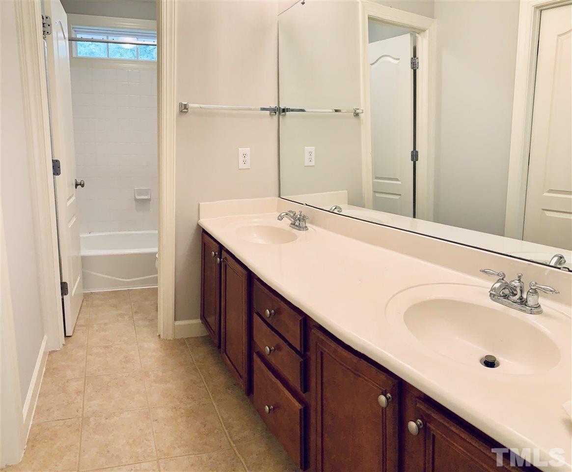 8917 Riverview Park Drive Raleigh, NC 27613 - Photo 24 of 29 a bathroom with a sink double vanity and a bathtub
