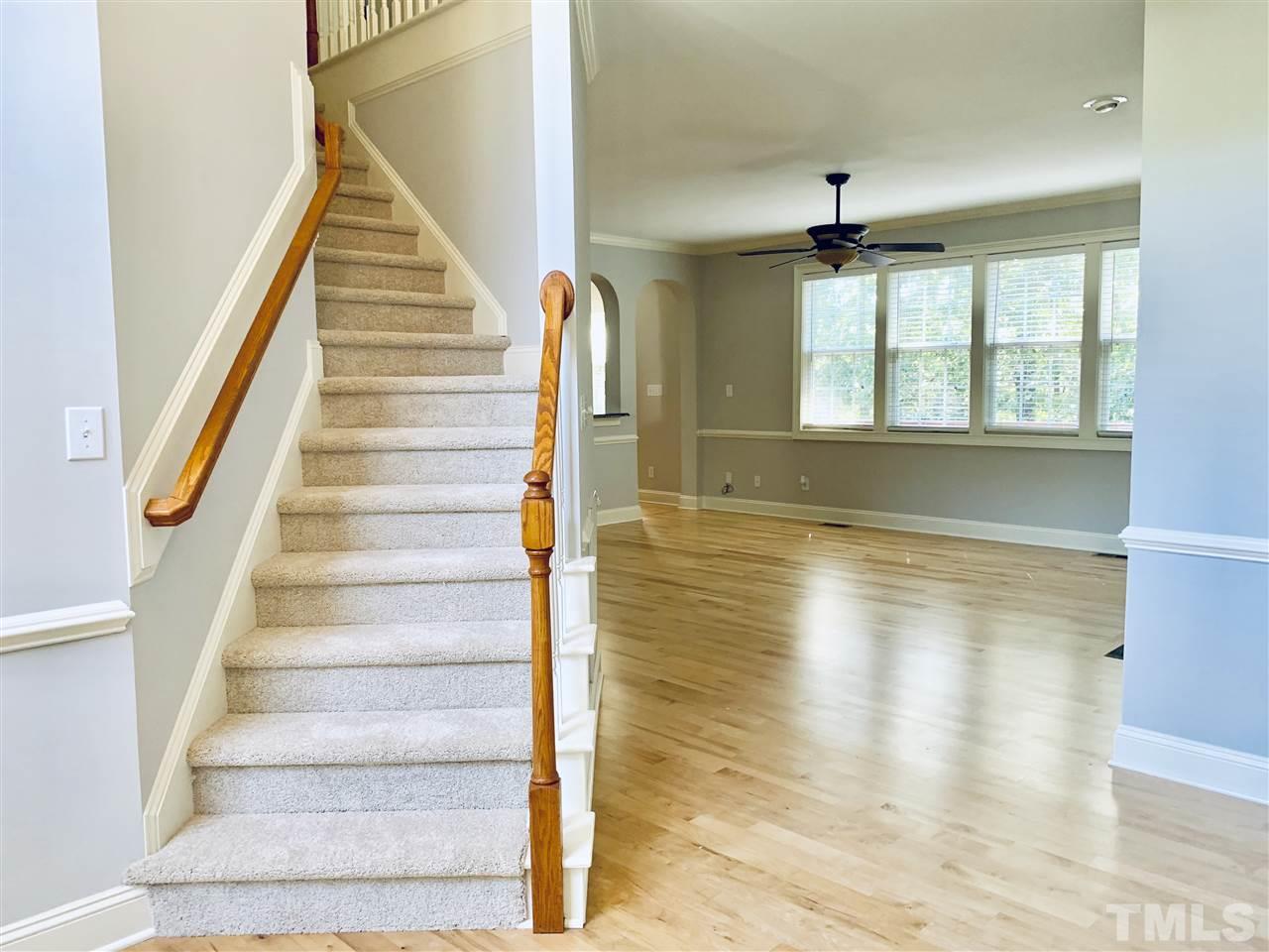 8917 Riverview Park Drive Raleigh, NC 27613 - Photo 4 of 29 a view of an entryway with wooden floor and staircase