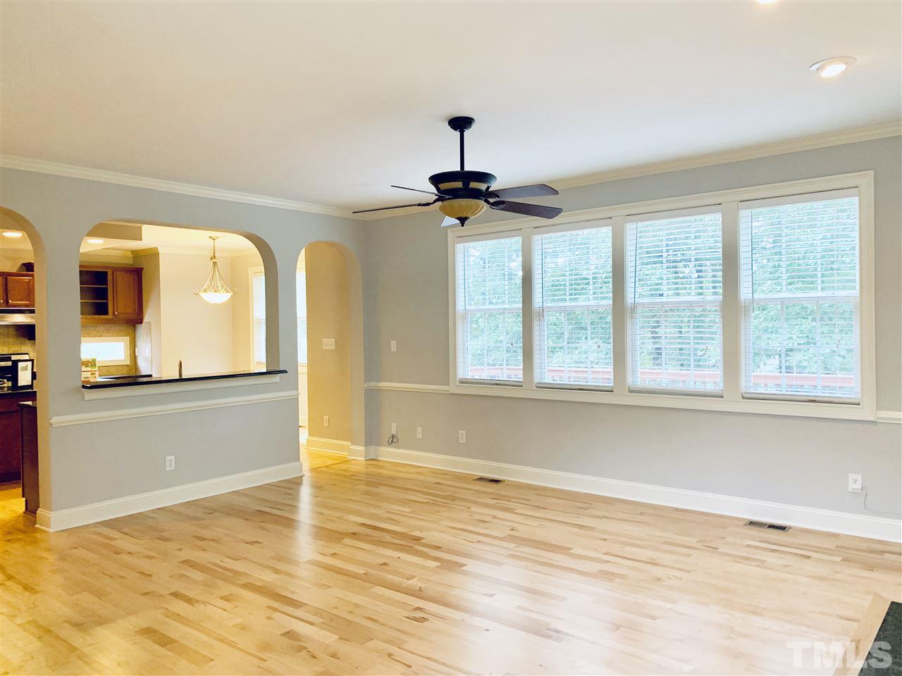 8917 Riverview Park Drive Raleigh, NC 27613 - Photo 7 of 29 a view of a room with wooden floor and a window