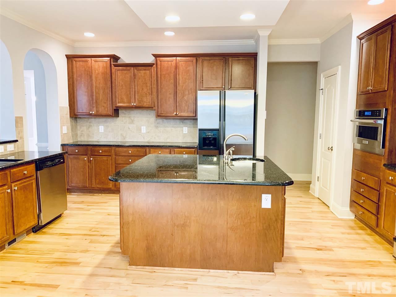 8917 Riverview Park Drive Raleigh, NC 27613 - Photo 9 of 29 a kitchen with stainless steel appliances granite countertop a sink counter space and cabinets
