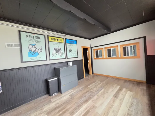 a view of a livingroom with wooden floor and a window