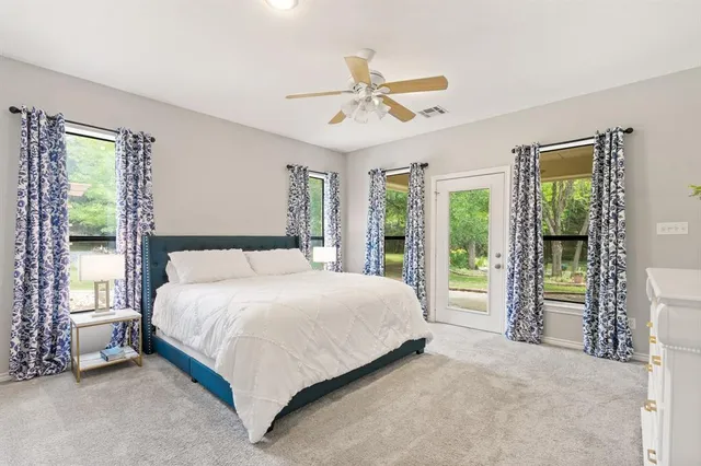 a bedroom with a large bed and a chandelier
