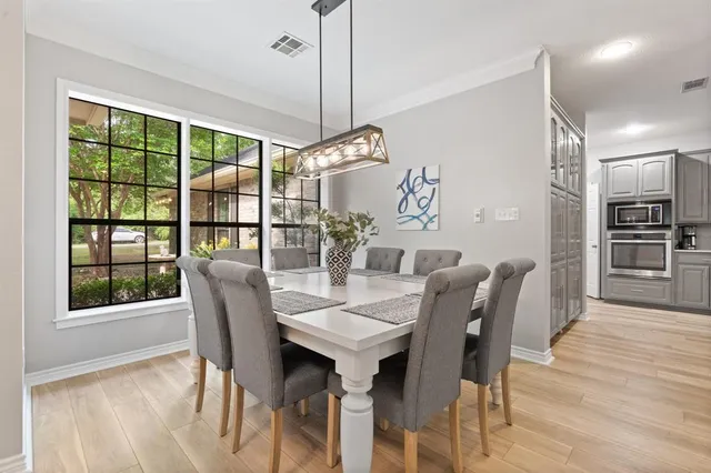 a view of a dining room with furniture window and wooden floor