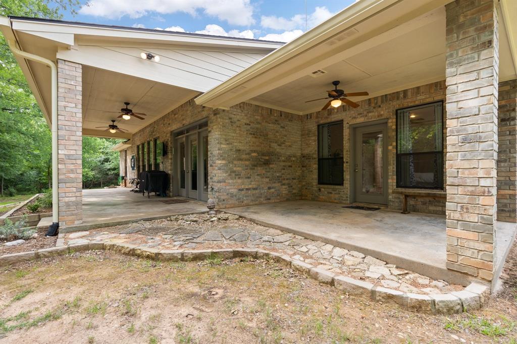 12041 Shady Creek Drive Whitney, TX 76692 - Photo 22 of 40 a view of a hallway with wooden walls and floor to ceiling window