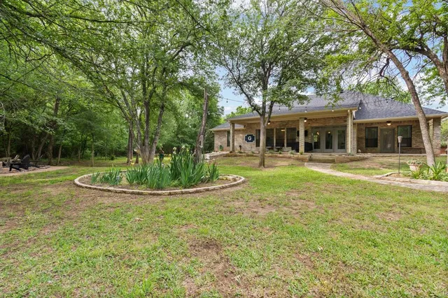 a view of a house with a yard patio and swimming pool