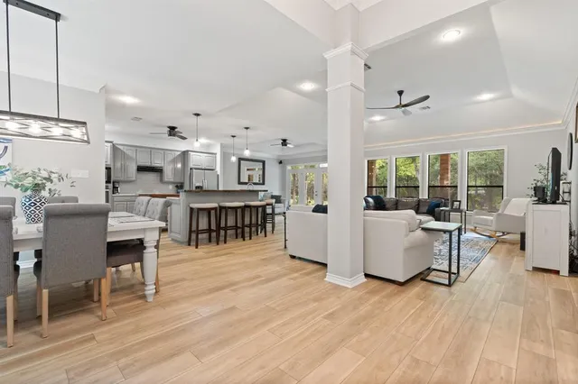 a living room with lots of furniture and kitchen view