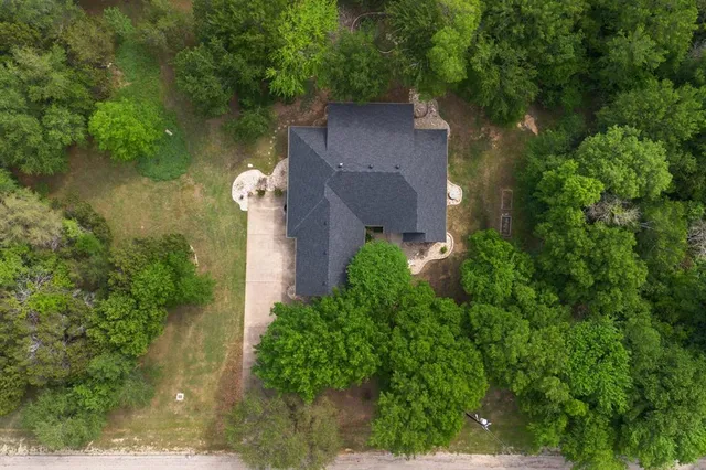 an aerial view of a house with outdoor space and a lake view