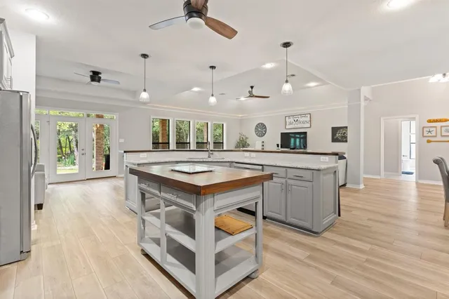 a kitchen with a stove and a wooden floor