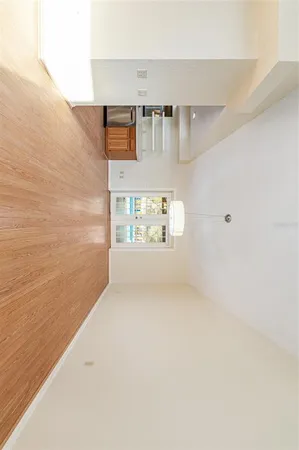 a view of a room with window wooden floor and a ceiling fan