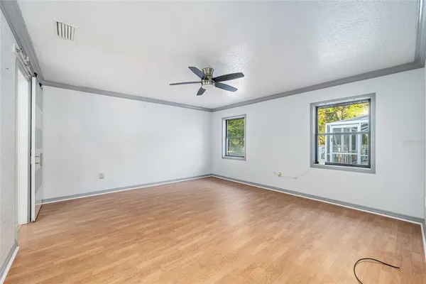 a view of an empty room with a ceiling fan
