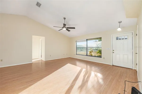 wooden floor in an empty room with a window
