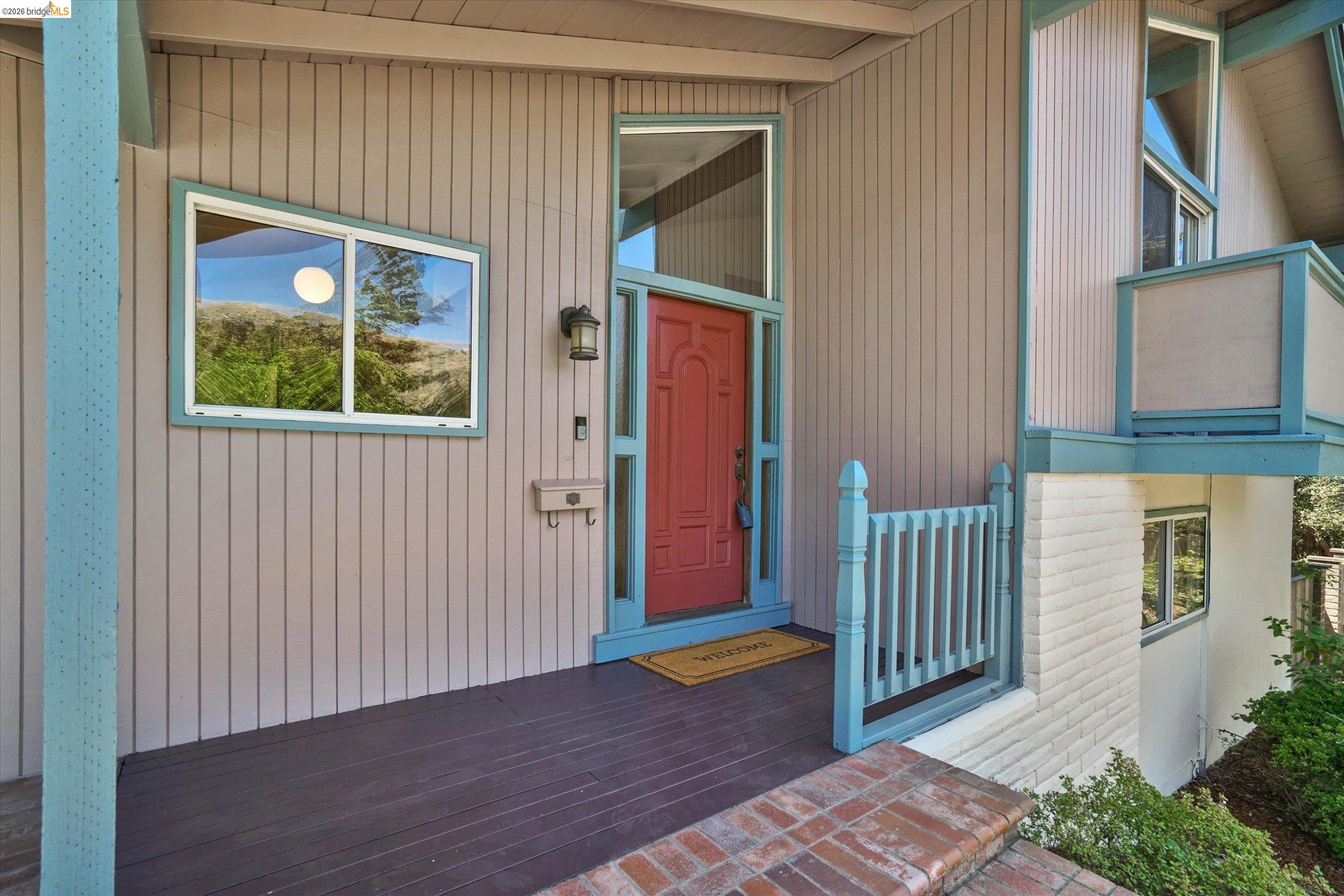 2826 Wright Avenue Pinole, CA 94564 - Photo 8 of 70 Red entry door with sidelight and transom, complemented by a board-and-batten exterior