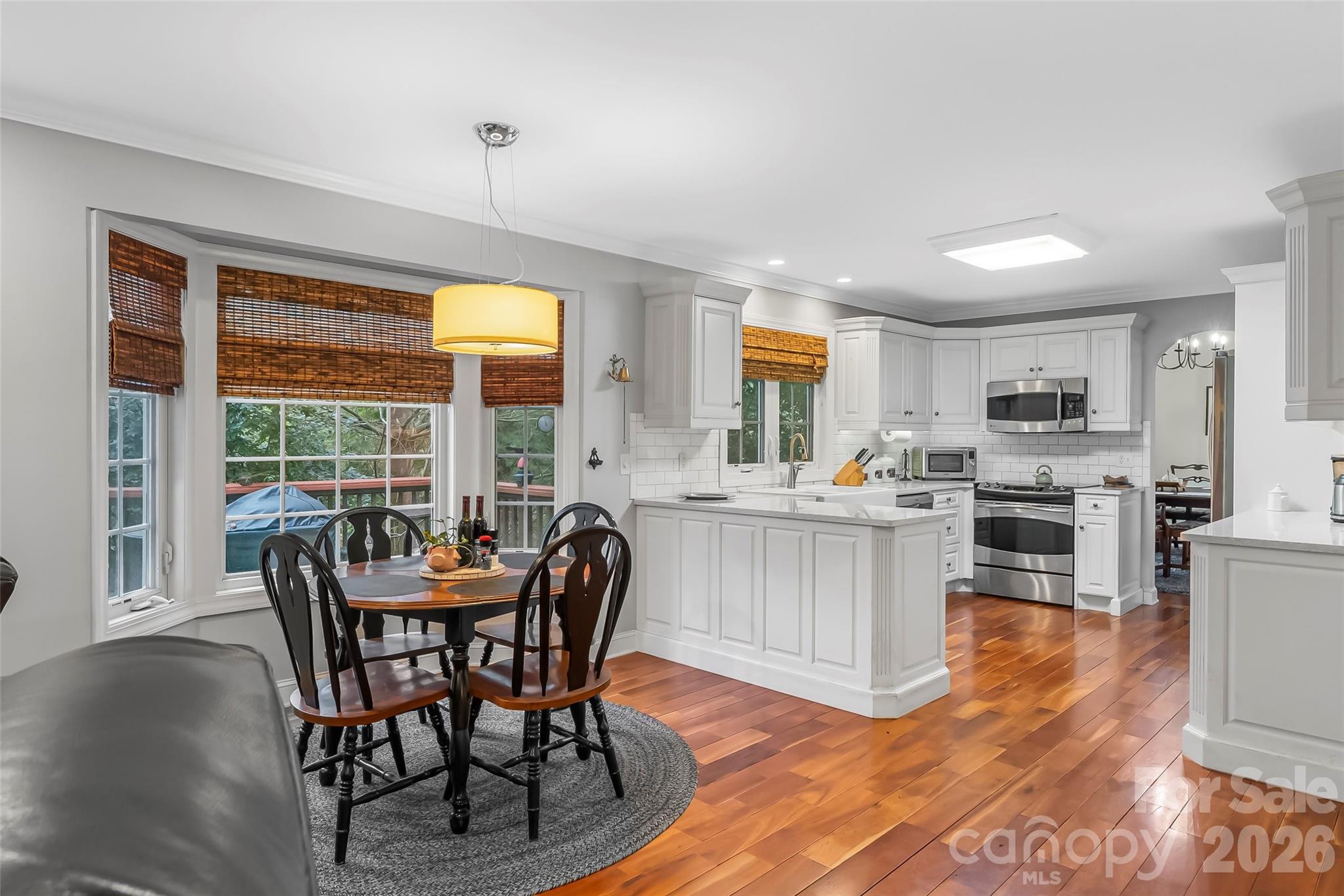 1726 Waterford Way Morganton, NC 28655 - Photo 11 of 45 a open dining room with stainless steel appliances granite countertop furniture wooden floor and a kitchen view