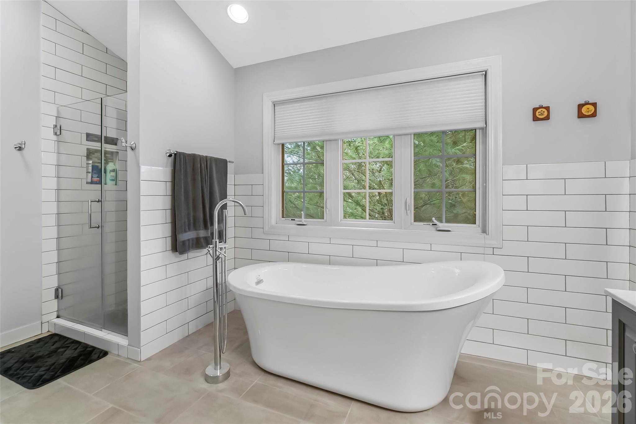 1726 Waterford Way Morganton, NC 28655 - Photo 27 of 45 a white bath tub sitting in a en suite bathroom next to a window
