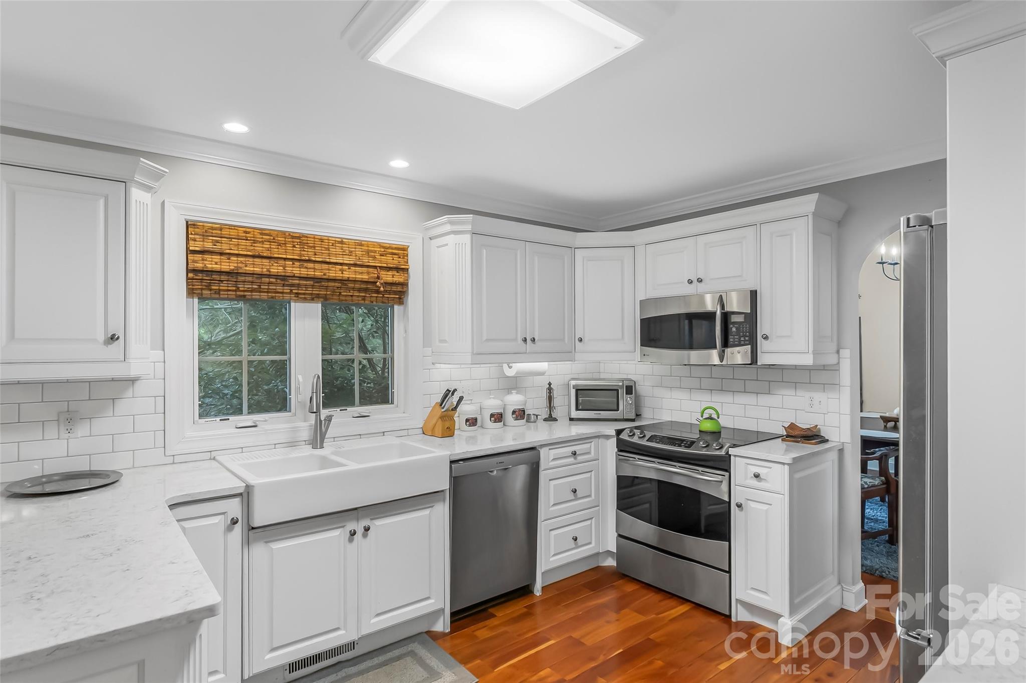 1726 Waterford Way Morganton, NC 28655 - Photo 9 of 45 a kitchen with stainless steel appliances white cabinets a sink a stove a refrigerator and microwave