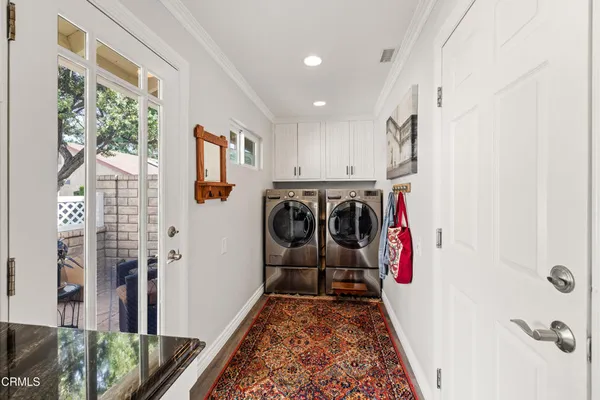 a view of a hallway with a washer and dryer