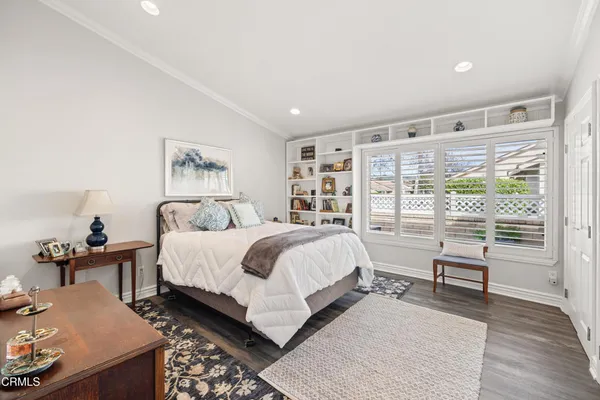 a bed room with a bed and a chair