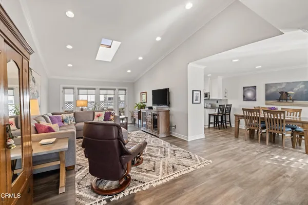 a living room with lots of furniture and kitchen view