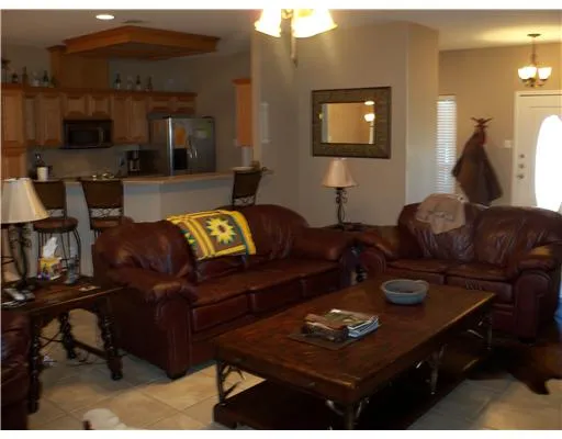 a living room with furniture and a lamp