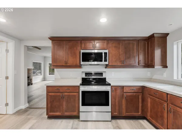 a kitchen with a sink stove and microwave