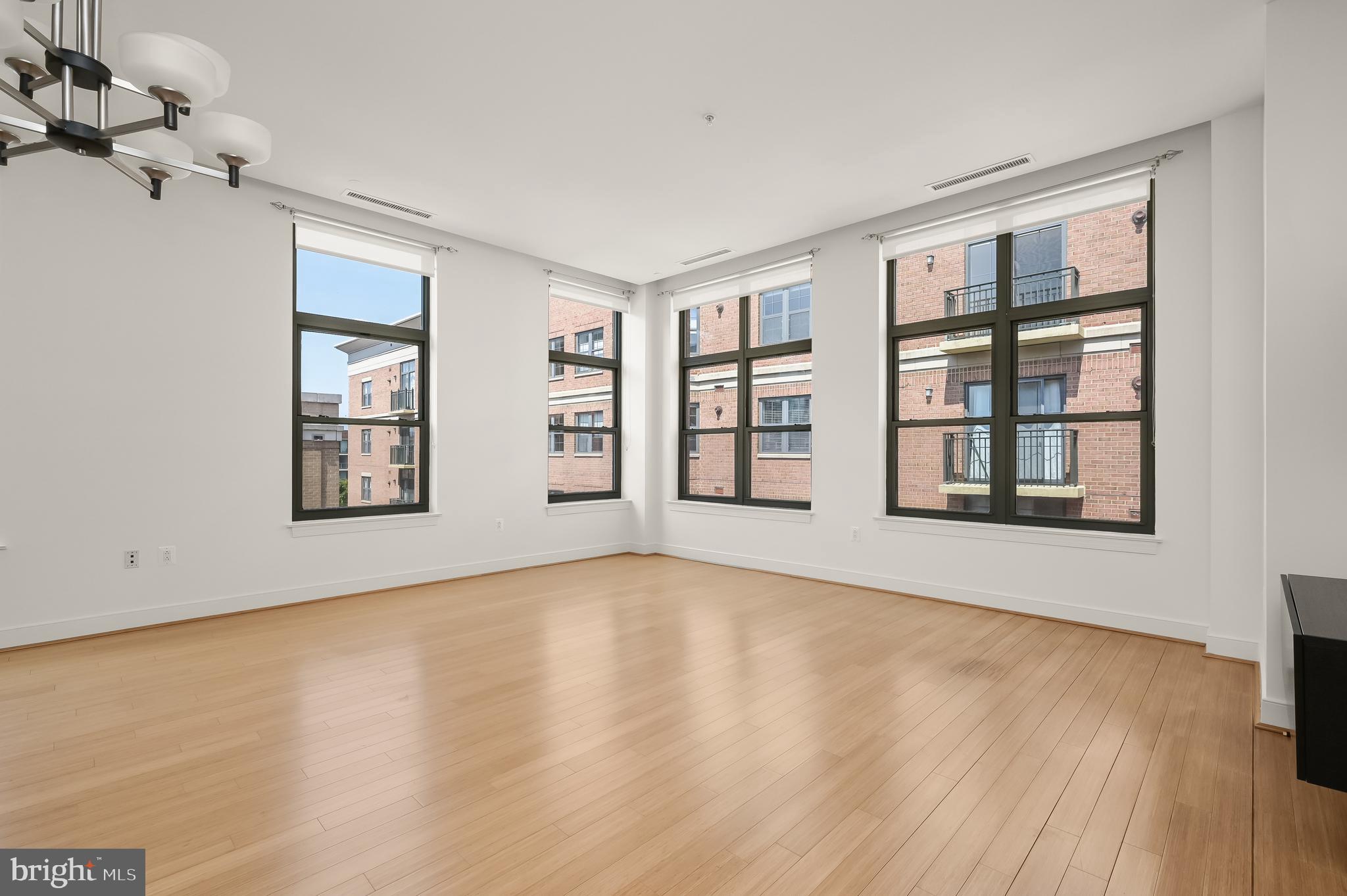 2425 L Street Northwest, Unit 617 Washington, DC 20037 - Photo 12 of 36 a view of an empty room with a window and wooden floor