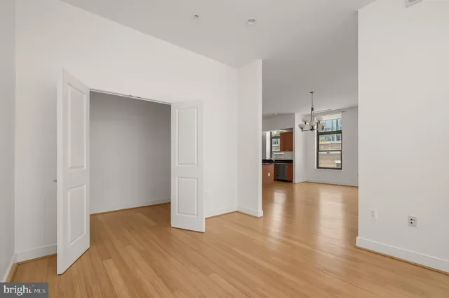 a view of a kitchen with wooden floor and a refrigerator