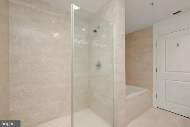 a bathroom with a bathtub and shower