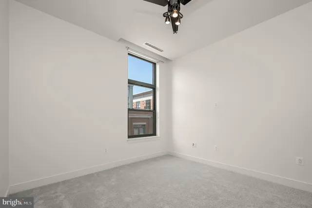 an empty room with a empty space and windows