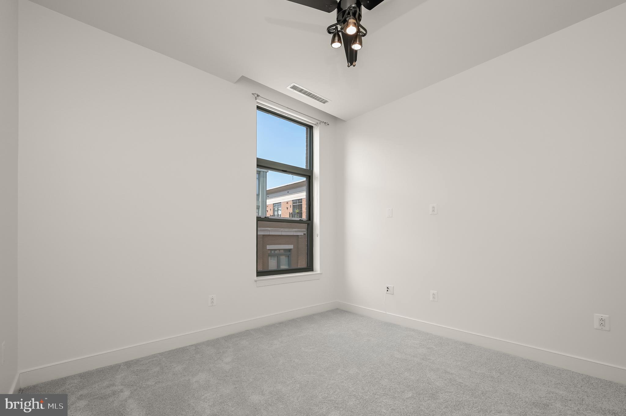 2425 L Street Northwest, Unit 617 Washington, DC 20037 - Photo 24 of 36 an empty room with a empty space and windows