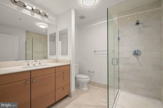 a bathroom with a double vanity sink toilet and shower