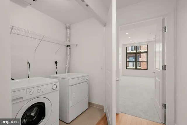 a view of a hallway with washer and dryer