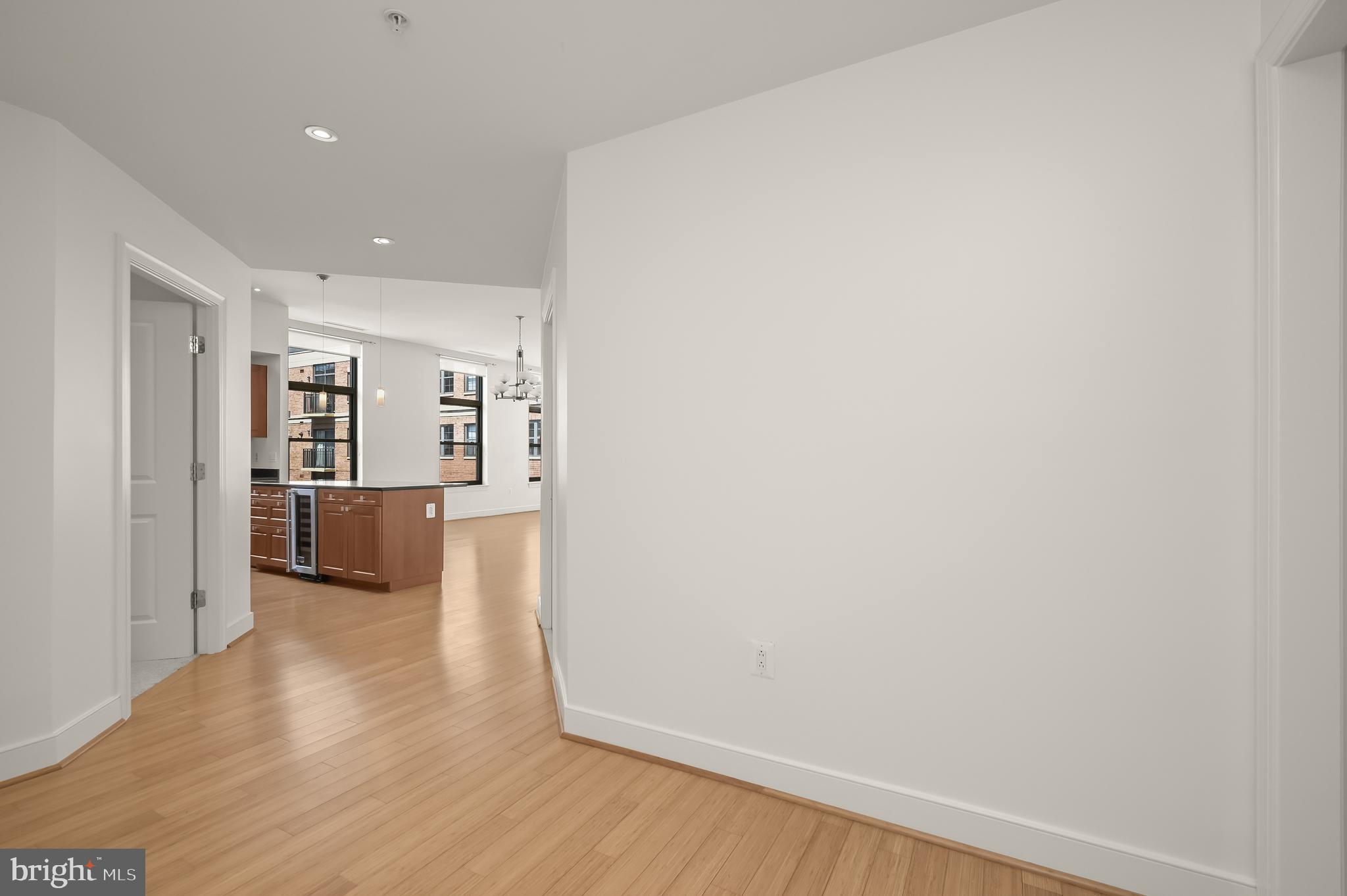 2425 L Street Northwest, Unit 617 Washington, DC 20037 - Photo 3 of 36 a view of a big room with wooden floor and a kitchen