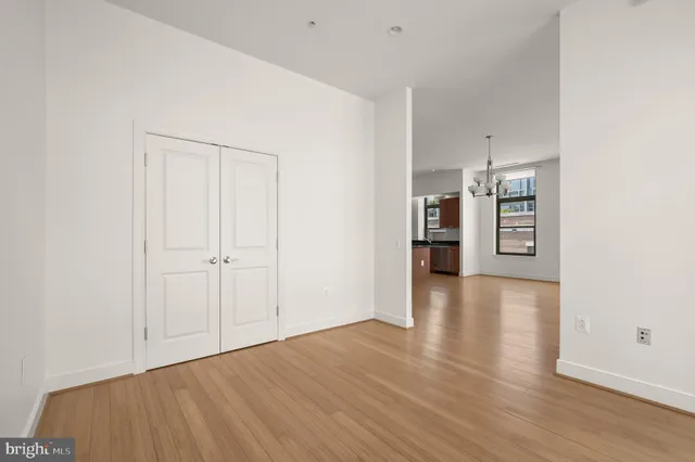 a view of a kitchen with wooden floor and a refrigerator