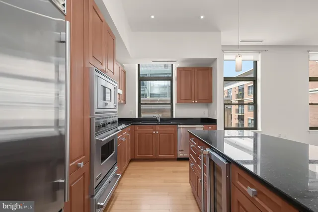 a kitchen with stainless steel appliances granite countertop a stove and a sink