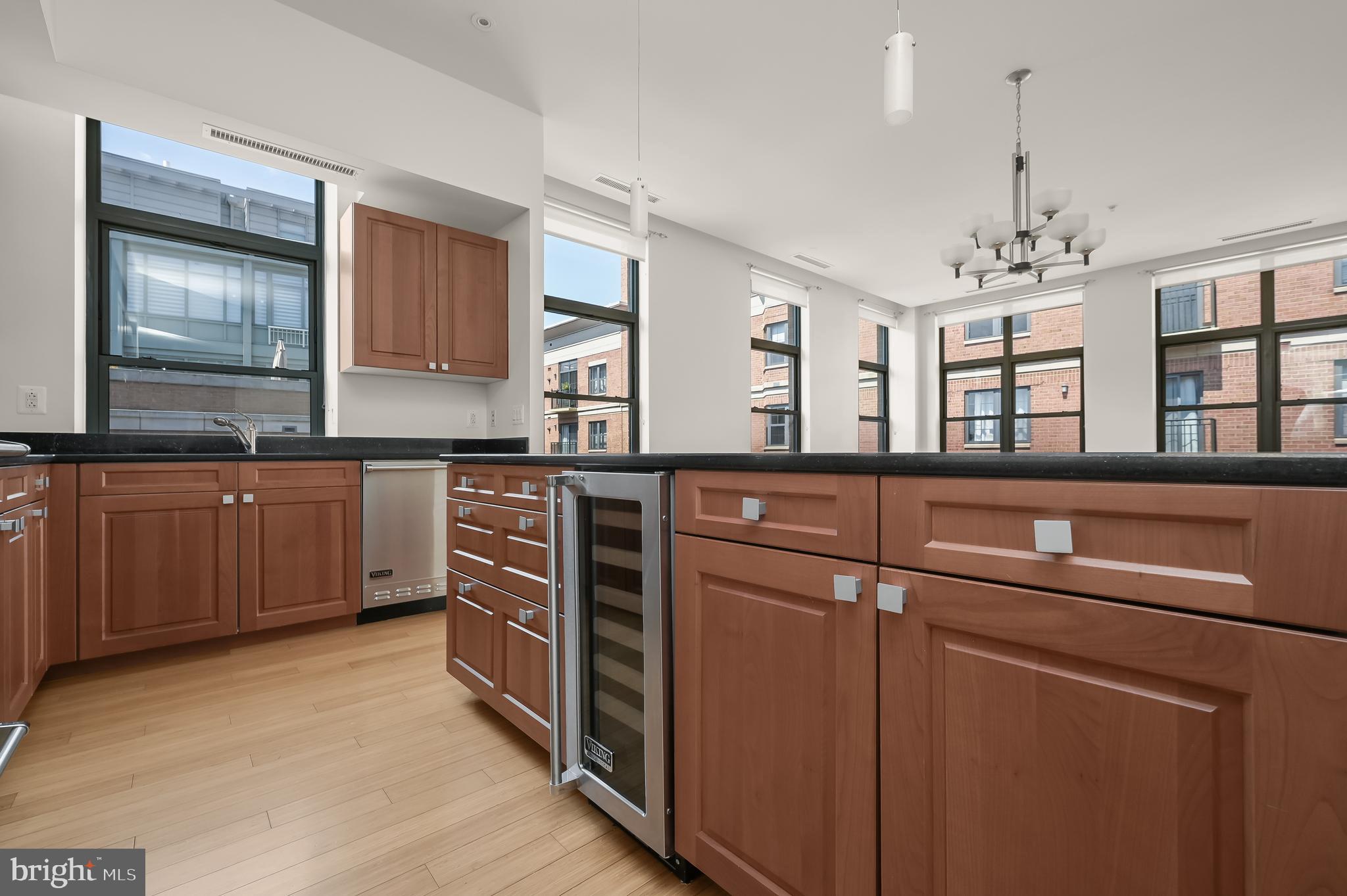 2425 L Street Northwest, Unit 617 Washington, DC 20037 - Photo 7 of 36 a kitchen with stainless steel appliances granite countertop a sink and cabinets